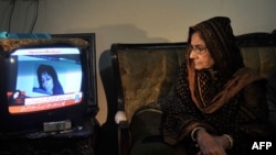 In Karachi, Ismat Siddiqui, the mother of Aafia Siddiqui, watches a news report following the court verdict against her daughter.