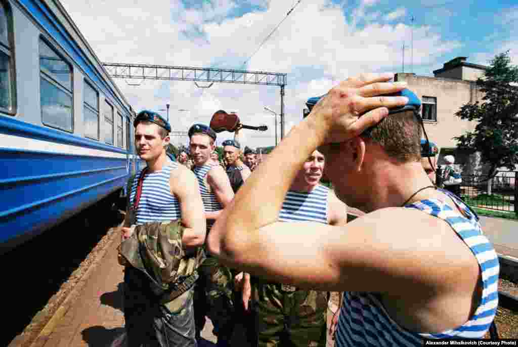 Soldiers wearing the blue beret of the special forces wait for the train home. 