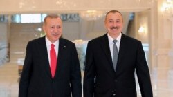 Azerbaijan -- Turkish President Recep Tayyip Erdogan, left, and Azerbaijani President Ilham Aliyev walk before a meeting in Baku, October 14, 2019