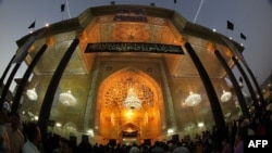 Shi'ite pilgrims gather at the shrine of Imam Musa al-Kadhim in northern Baghdad's Kadhimiyah neighborhood, as they commemorate the death anniversary of the revered Shiite imam on June 14.