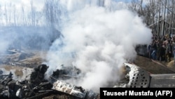 FILE: Smoke billows from the remains of an Indian Air Force aircraft after it crashed in Budgam district, on the outskirts of Srinagar on February 27.