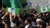 جثامين أربعة لاجئين أفغان قتلوا في سوريا، تُشَيّع في مدينة مشهد الإيرانية 15 آيار 2014