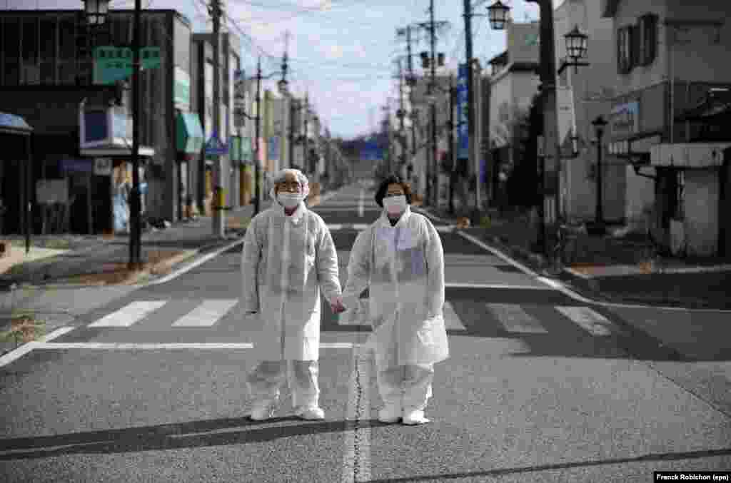 Yuzo Mihara (left) and his wife, Yuko, pose on a deserted street in the town of Namie, inside the nuclear exclusion zone near Fukushima, Japan, on February 22. Residents of the town were forced to abandon their homes after the 2011 nuclear disaster, and only return briefly to retrieve their belongings. 