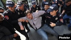 Armenia - Police officers arrest an opposition protester in Yerevan, May 18, 2022.