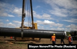 Workers move a pipe at a construction site on the extension of Russia's TurkStream gas pipeline in Letnitsa, Bulgaria, in June 2020.