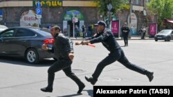 Armenia -- A police officer detains a participant in an anti-government protest in Yerevan, May 18, 2022.