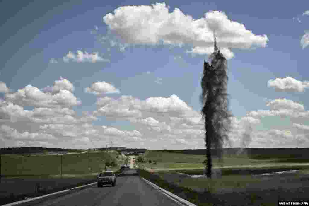 A mortar explodes next to a road leading to the city of Lysychansk in eastern Ukraine&#39;s Luhansk region on May 23.