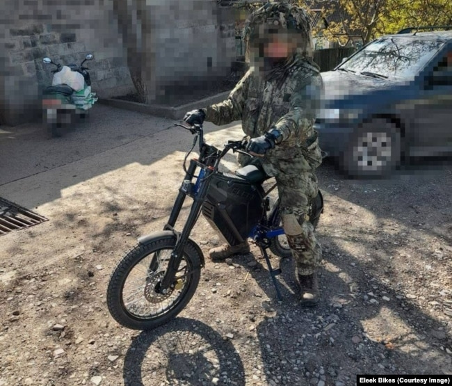 An edited photo of a Ukrainian serviceman on an electric bike.