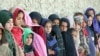 Afghan girls wait for the start of an educational event organized by Pen Path in Kandahar Province on May 17. This was the first time the NGO sent its mobile school and library to the area.