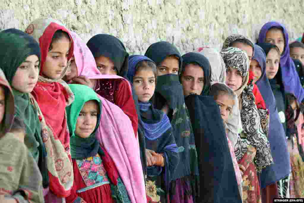 Afghan girls wait for the start of an educational event organized by Pen Path in Kandahar Province on May 17. This was the first time the NGO sent its mobile school and library to the area.