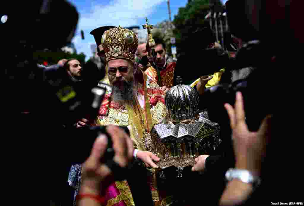An Orthodox priest carries the container holding the relics of Cyril and Methodius. &nbsp;