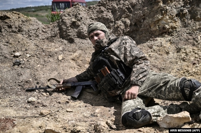 A Ukrainian soldier takes cover during Russian shelling outside the city of Lysychansk on May 23.