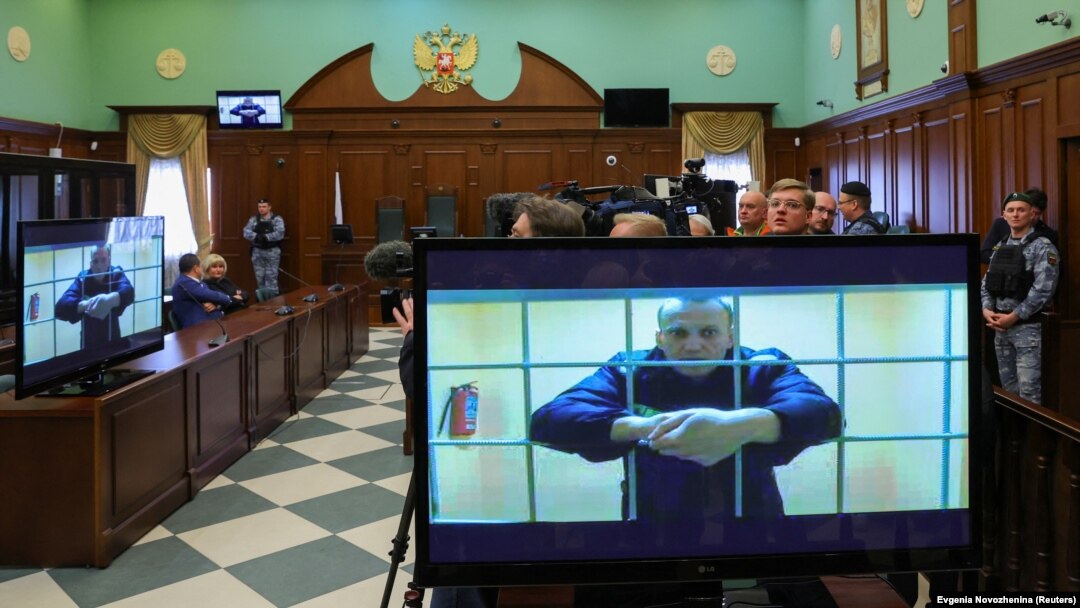 Russian opposition leader Aleksei Navalny is seen on screens via video link from the IK-2 corrective penal colony in Pokrov during a court hearing to consider an appeal against his prison sentence in Moscow on May 24.