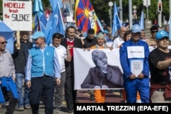 Demonstrators march on May 13 in Geneva outside UN headquarters over what they say is a lack of attention to the persecution of Uyghurs and other groups in China by UN High Commissioner for Human Rights Michelle Bachelet.