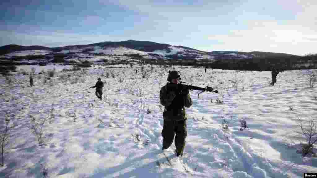 A soldier of the Armed Forces of Bosnia and Herzegovina takes aim during an exercise near Banja Luka. The drill, which tests soldiers on conquering a territory and rescuing the wounded from a war zone, is the final one for the basic officer trainee course. (Reuters/Dado Ruvic)