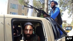 Taliban fighters on patrol in the streets of Herat. 