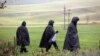 Police officers walk near the site of an explosion in the Polish village of Przewodownear near the border with Ukraine. 