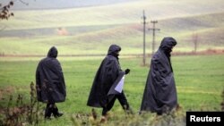 Police officers walk near the site of an explosion in the Polish village of Przewodownear near the border with Ukraine. 