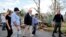 U.S. President Donald Trump walks past hurricane wreckage as he participates in a walking tour in Puerto Rico on October 3.