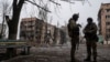 Ukrainian marines stand in the street in the frontline city of Vuhledar on February 25.