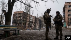 Ukrainian marines stand in the street in the frontline city of Vuhledar on February 25.