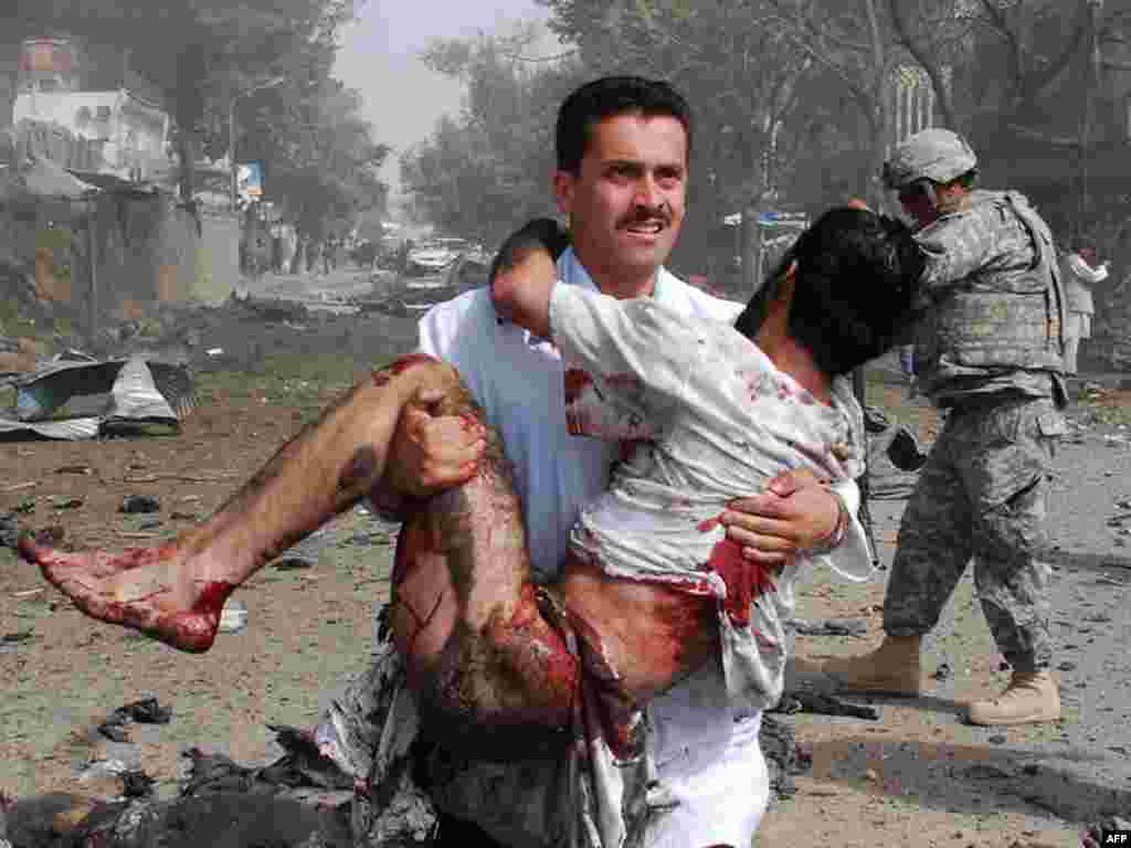 Bombing of Indian Embassy in Afghanistan - Afghan security forces and medical personnel assist survivors at the scene of a suicide bombing outside the Indian Embassy in Kabul, 07July 2008 