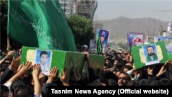 A funeral for four Afghan refugees who were killed in Syria were held in Mashhad, Iran on May 15, 2014.