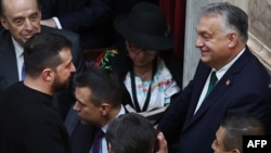 Hungarian Prime Minister Viktor Orban (left) said that he agreed to a proposal for a future meeting with Ukrainian President Volodymyr Zelenskiy (right) when the two men had a brief conversation on the sidelines this month's swearing-in ceremony for Argentina's new president. 