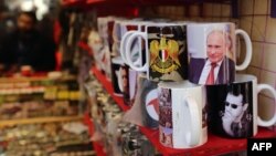 Căni cu portretele președinților Vladimir Putin și Bashar al-Assad, într-o tarabă din Damasc, 10 noiembrie 2015