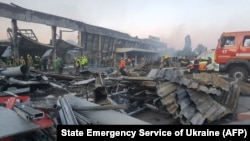 Rescuers working sift through rubble at the Amstor shopping center in Kremenchuk after it was hit by a Russian missile strike on June 27, 2022.