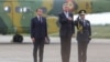 French President Emmanuel Macron (left) met with his Romanian counterpart, Klaus Iohannis (center), at Romania's NATO base on June 15. 