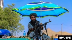 A Taliban fighter secures the venue of the "Grand Gathering" in Kabul on June 30. 