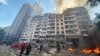 Rescuers work at a residential building damaged by a Russian missile strike in Kyiv on June 26.