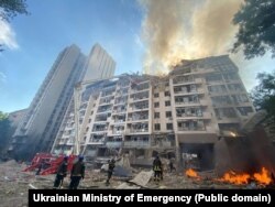 Рятувальники працюють у житловому будинку в столиці України, пошкодженому в результаті ракетного удару Росії. Київ, 26 червня 2022 року