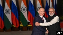 Indian Prime Minister Narendra Modi (right) greets Russian President Vladimir Putin before a meeting at Hyderabad House in New Delhi on December 6, 2021.