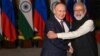 Indian Prime Minister Narendra Modi (right) greets Russian President Vladimir Putin before a meeting at Hyderabad House in New Delhi on December 6, 2021.