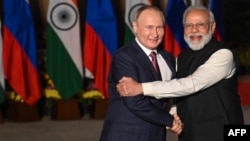 Indian Prime Minister Narendra Modi (right) greets Russian President Vladimir Putin before a meeting at Hyderabad House in New Delhi on December 6, 2021.