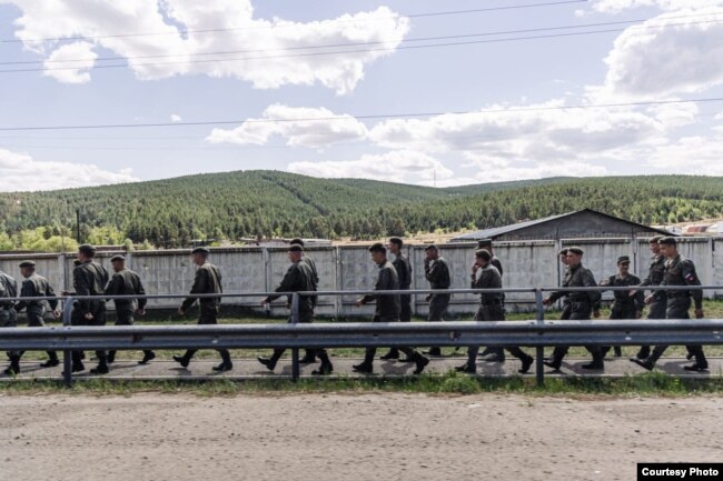 A unit of Russian soldiers walk through Buryatia on June 29.