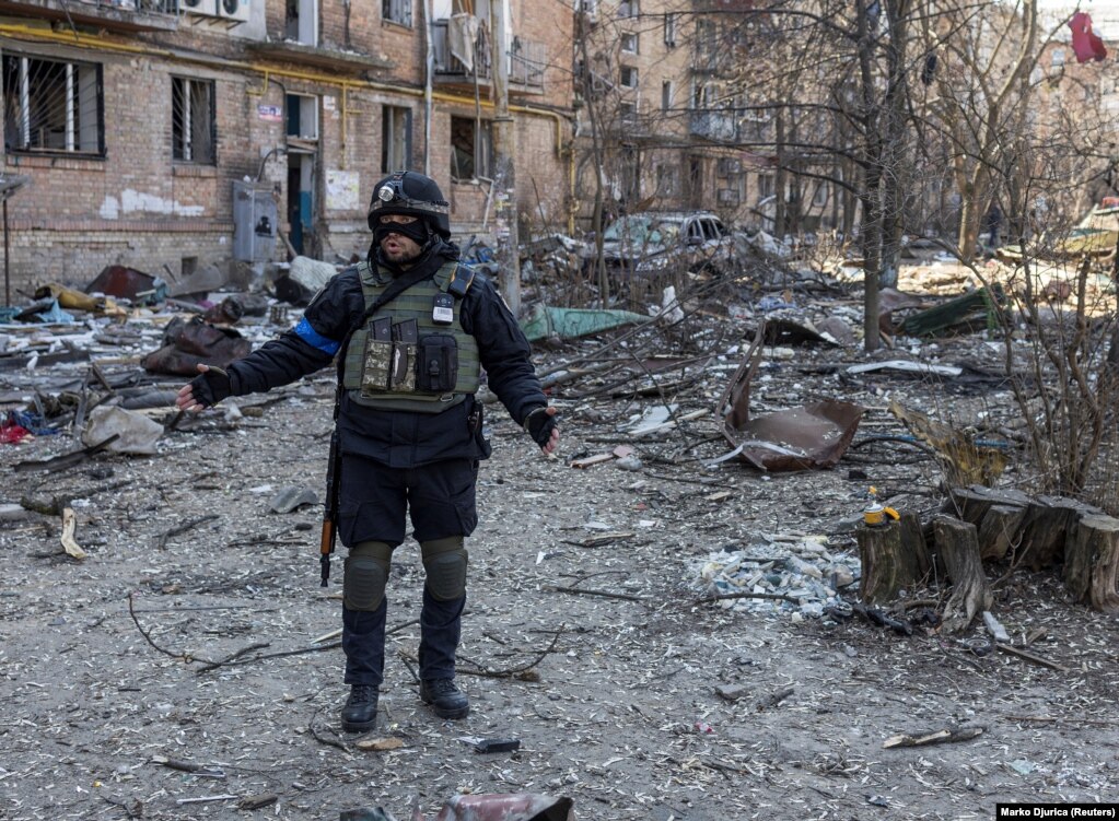 A Ukrainian policeman at the scene of an explosion in a residential area of Kyiv on March 18.