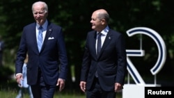 U.S. President Joe Biden (left) and German Chancellor Olaf Scholz chat as they arrive for the start of the G7 summit at Elmau Castle, near Garmisch-Partenkirchen, Germany, on June 26.