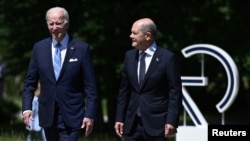 U.S. President Joe Biden (left) and German Chancellor Olaf Scholz chat as they arrive for the start of the G7 summit at Elmau Castle, near Garmisch-Partenkirchen, Germany, on June 26.
