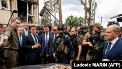 Italian Prime Minister Mario Draghi (second left), French President Emmanuel Macron (third left), and German Chancellor Olaf Scholz (right) visit Irpin on June 16.