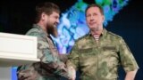 Chechnya leader Ramzan Kadyrov (left) and Viktor Zolotov, the head of Russia's National Guard, shake hands during a ceremony in Grozny to award decorations to military personnel and National Guard officers participating in the war in Ukraine.