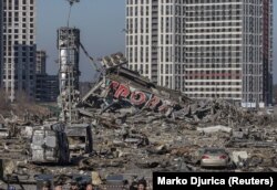 The scene of an apparent missile strike that destroyed a shopping center and killed eight people on March 20. The Kremlin claimed the area was being used by the Ukrainian military. A man was detained by the Ukrainian authorities for posting footage to TikTok showing military vehicles around the shopping center before the attack.