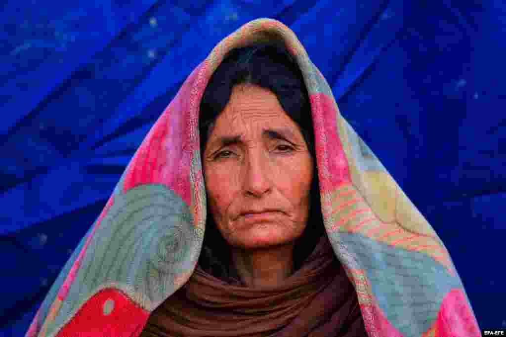 An Afghan woman sits outside a temporary shelter after an earthquake in the village of Gayan in Paktika Province. Some 1,150 people were killed and over 1,500 others injured in a devastating earthquake on June 22.