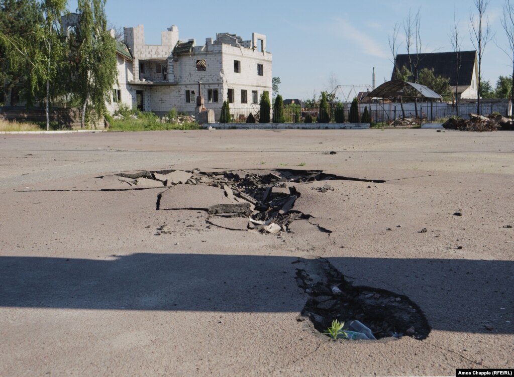 June 24. The burned remains of the apparent chassis of the tank were around 50 meters away on the other side of a highway.