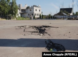 June 24. The burned remains of the apparent chassis of the tank were around 50 meters away on the other side of a highway.