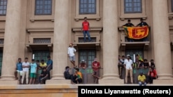 Demonstrators celebrate after entering the presidential secretariat after President Gotabaya Rajapaksa fled, amid the economic crisis in Colombo on July 9.