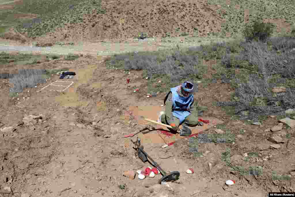 A deminer searches for unexploded ordnance in the Kabul Province. According to the DRC, aid groups do the majority of demining work in Afghanistan.&nbsp;