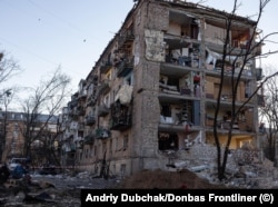 An apartment building that had some of its outer walls blasted off after an explosion from an apparent missile strike in a Kyiv suburb on March 18.